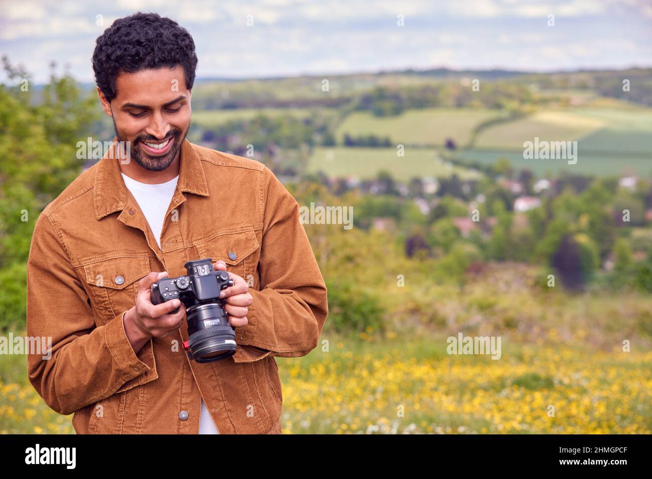 Man With Digital DSLR Camera Taking Photos In Countryside Stock Photo close-ups-still-getting-the-hang-of-taking-photos-in-a-mir-flickr