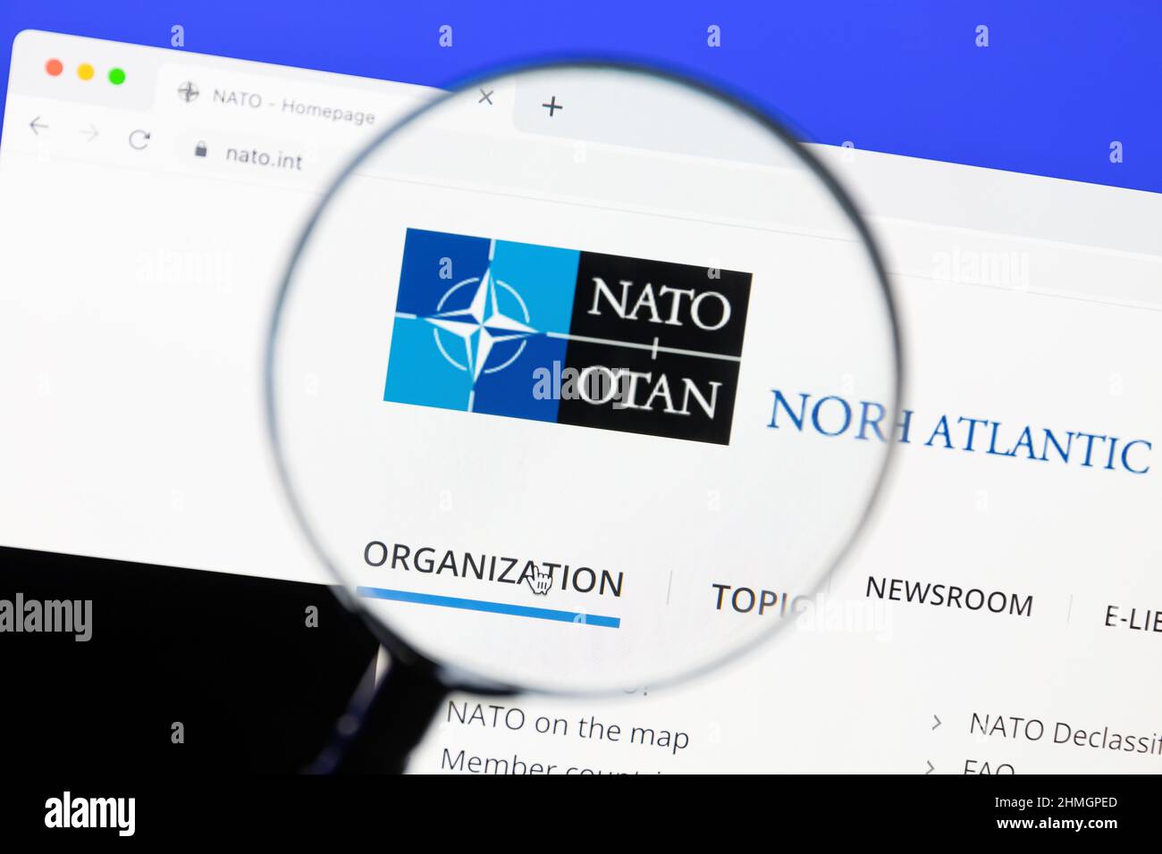 Ostersund, Sweden - Jan 23, 2022: NATO website under a magnifying glass. NATO is an intergovernmental military alliance. Stock Photo