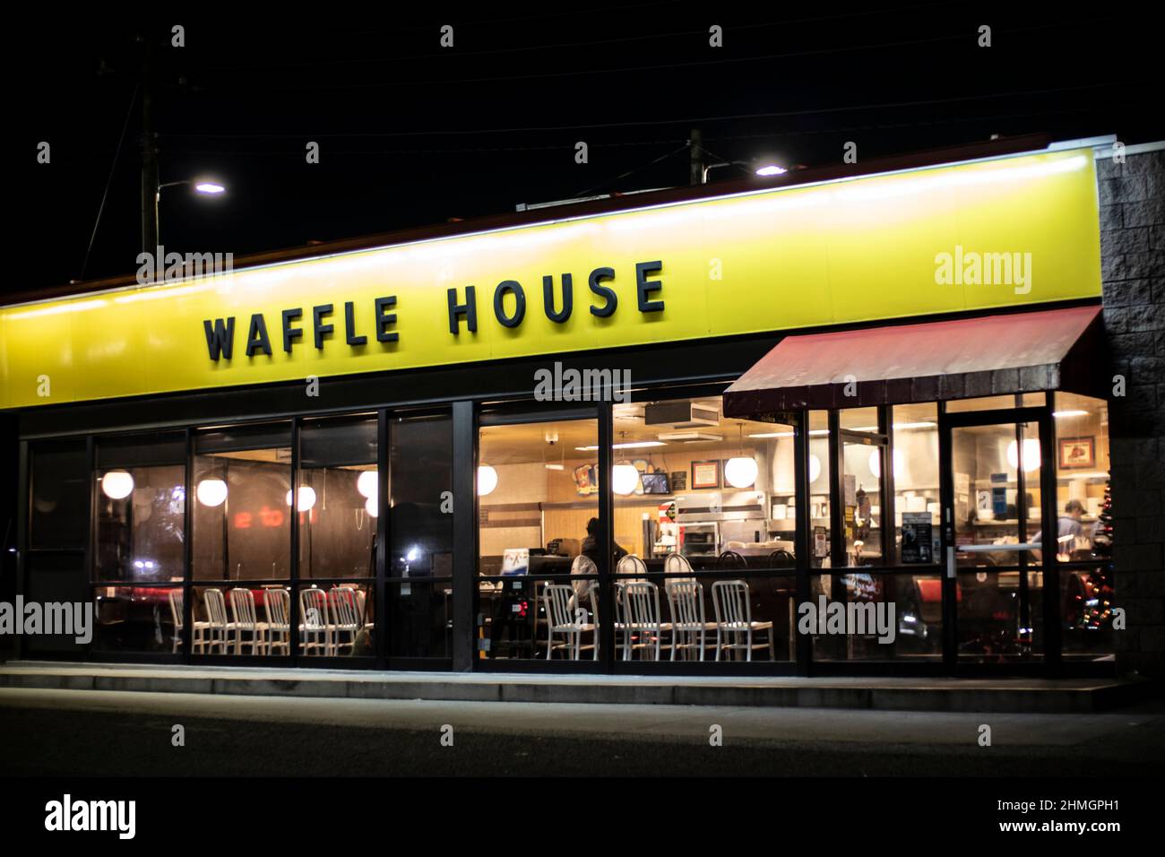 Augusta, Ga USA 12 22 20 Waffle House restaurant at night people inside side view Stock Photo