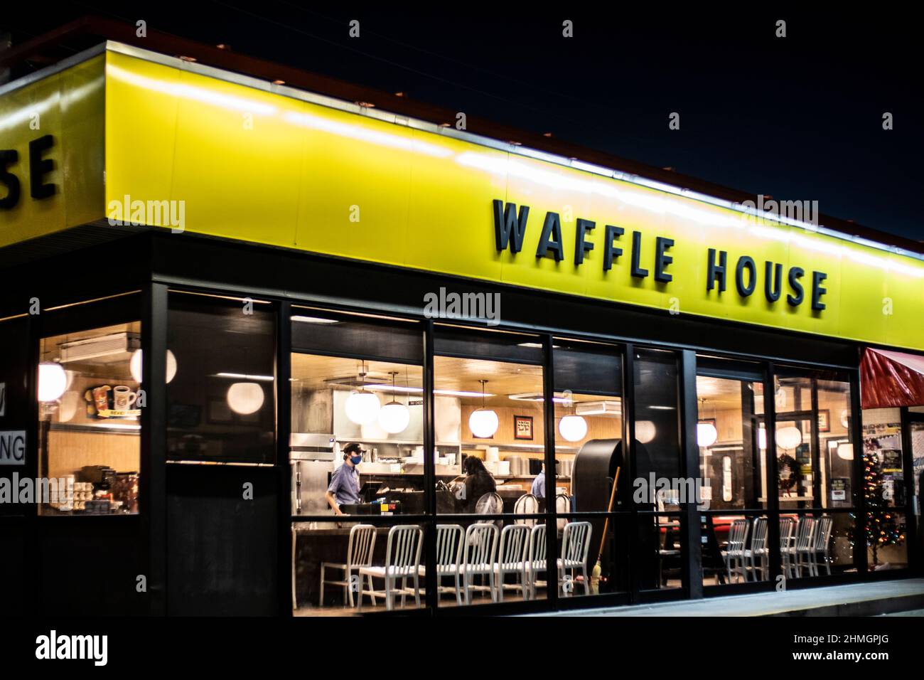 Augusta, Ga USA - 12 22 20: Waffle House restaurant at night people inside corner view Belair road Stock Photo