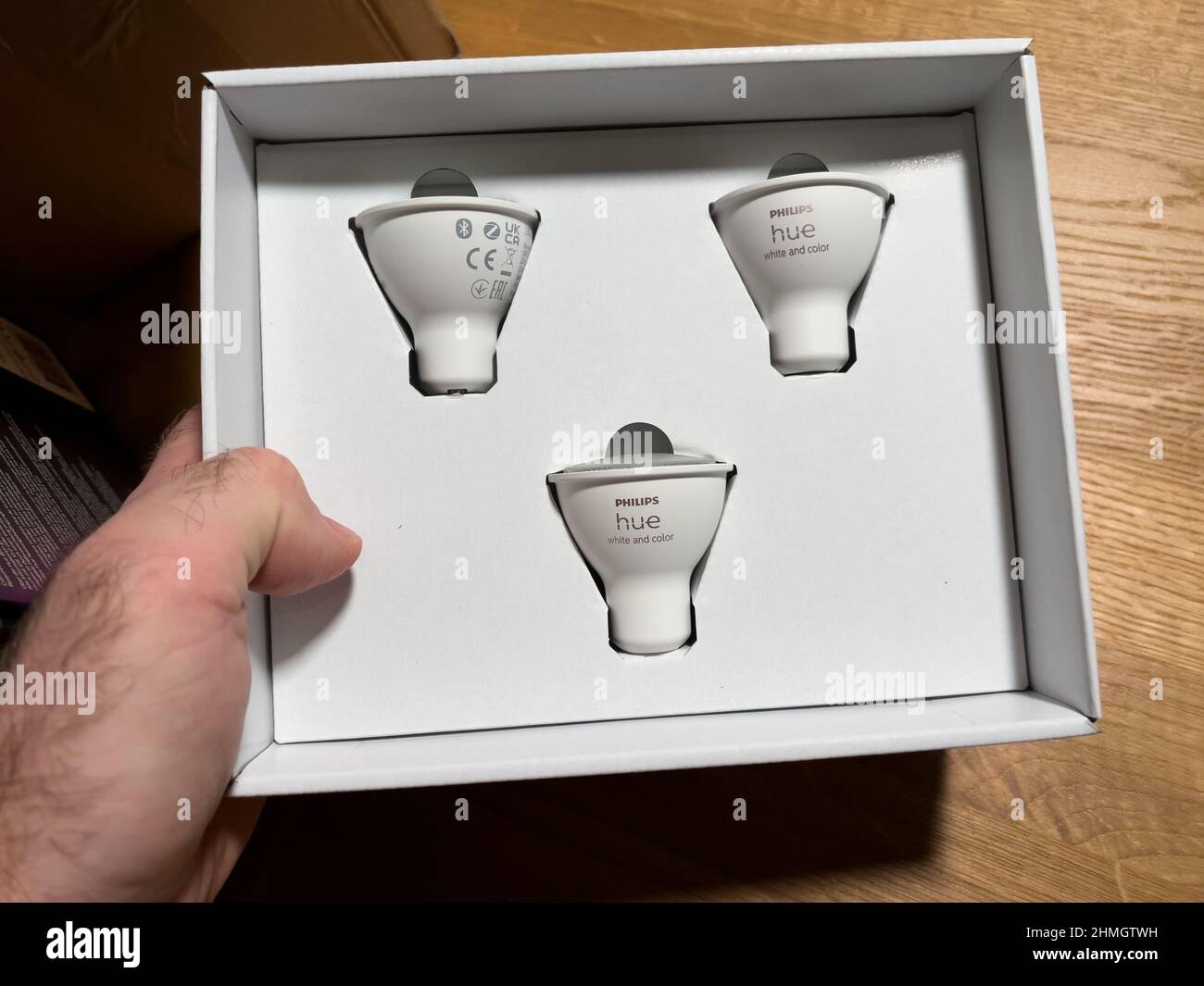 Munich, Germany - Dec 9, 2021: POV male hand unboxing Philips Hue GU10  white and color lamps Stock Photo - Alamy