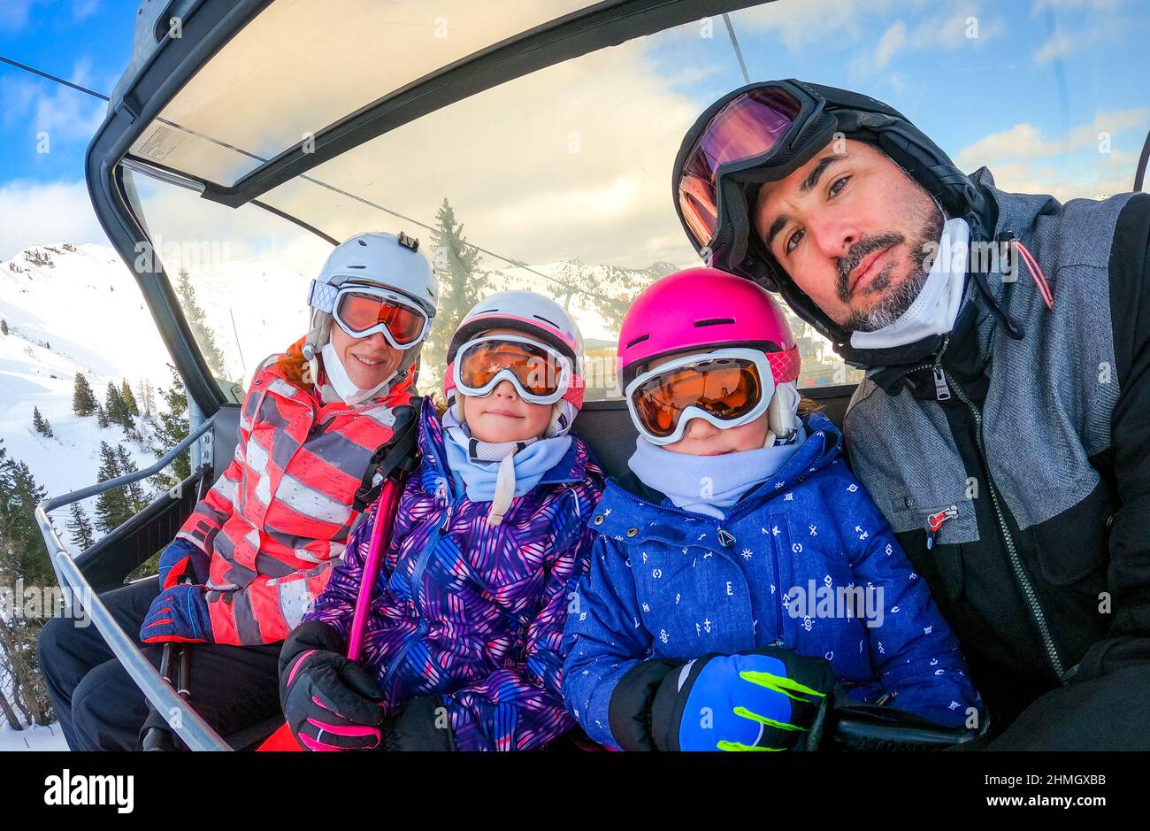Cute Girl Skier Skiing With Family On Mountain Stock Photo