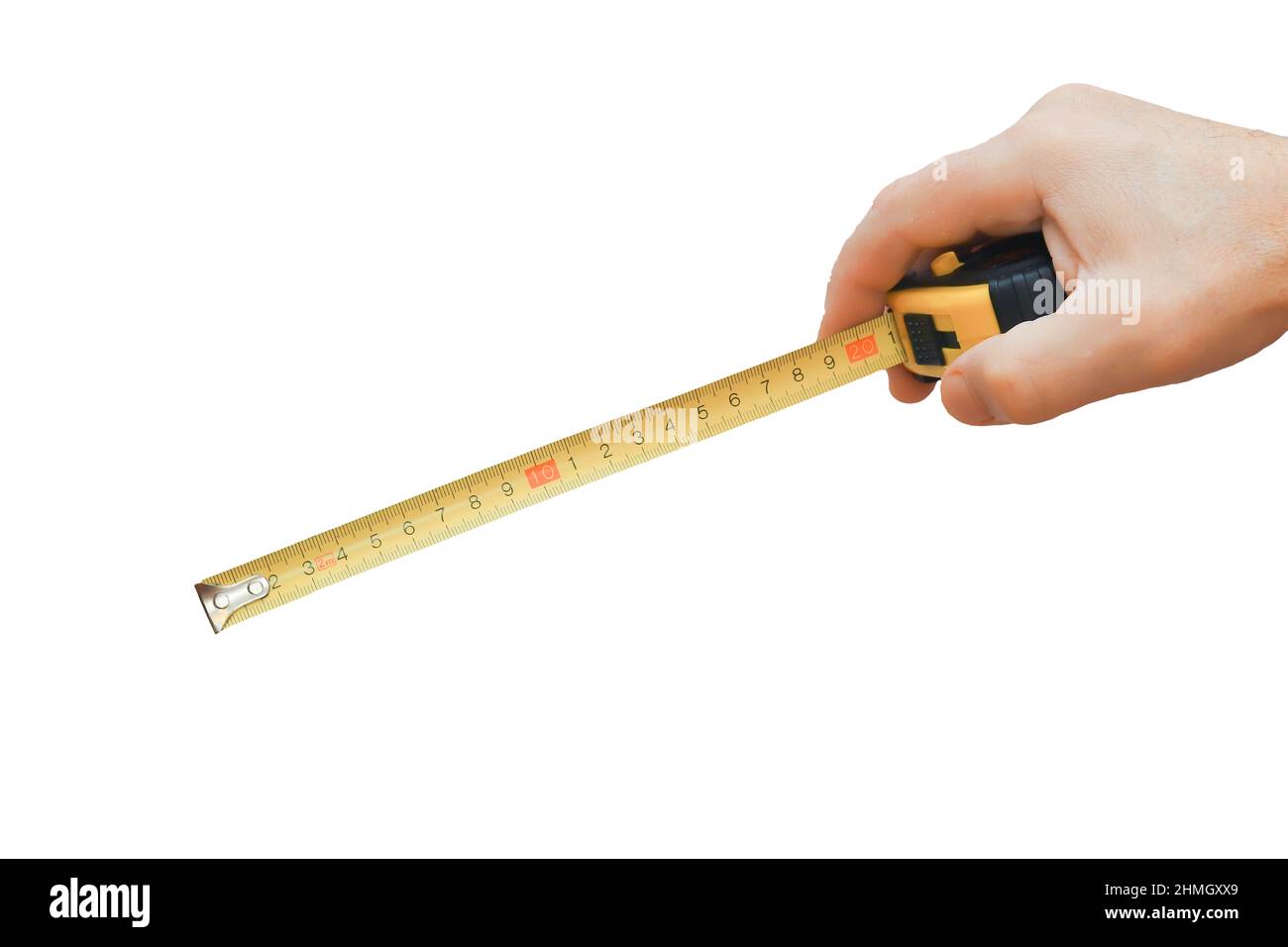 A black tape measure with a yellow ruler in the man's hand in close-up. Stock Photo