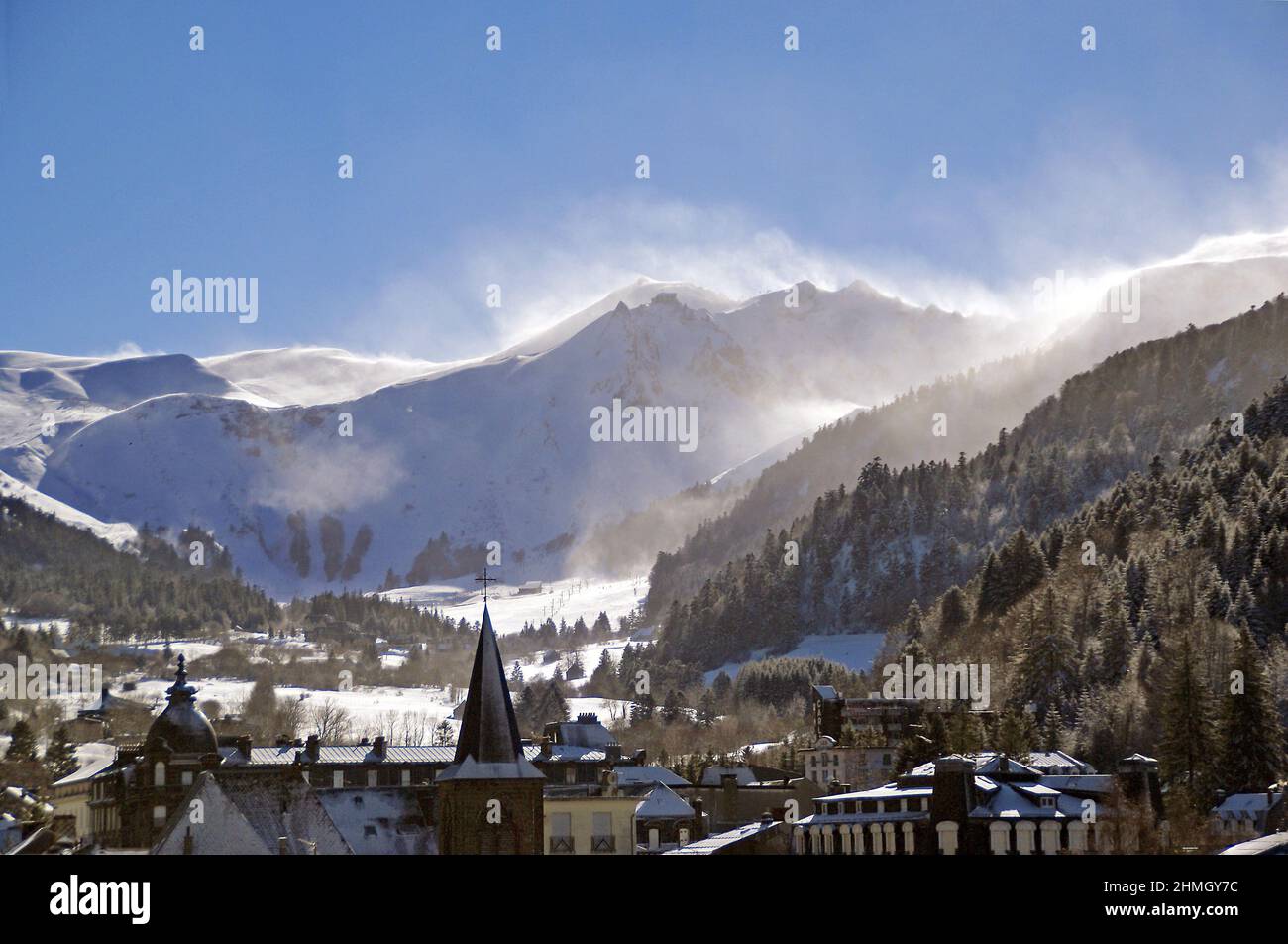 The town of Mont-Dore, with blown snow over the Massif de Sancy Stock Photo