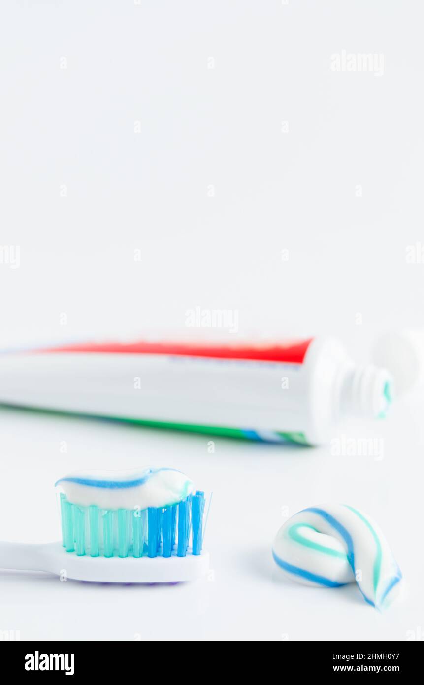 A tube of toothpaste and a toothbrush on white background closeup Stock ...