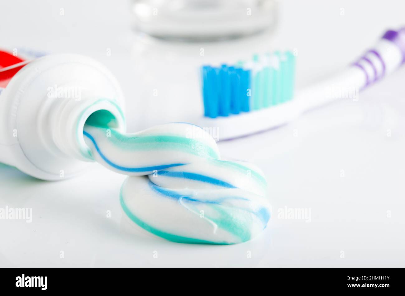 Toothbrush, tube of toothpaste and a glass on a white background Stock ...