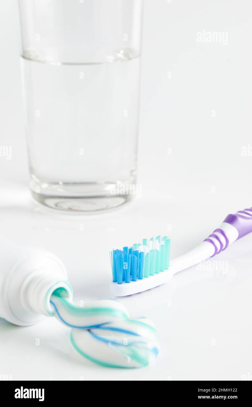 Toothbrush, tube of toothpaste and a glass on a white background Stock ...
