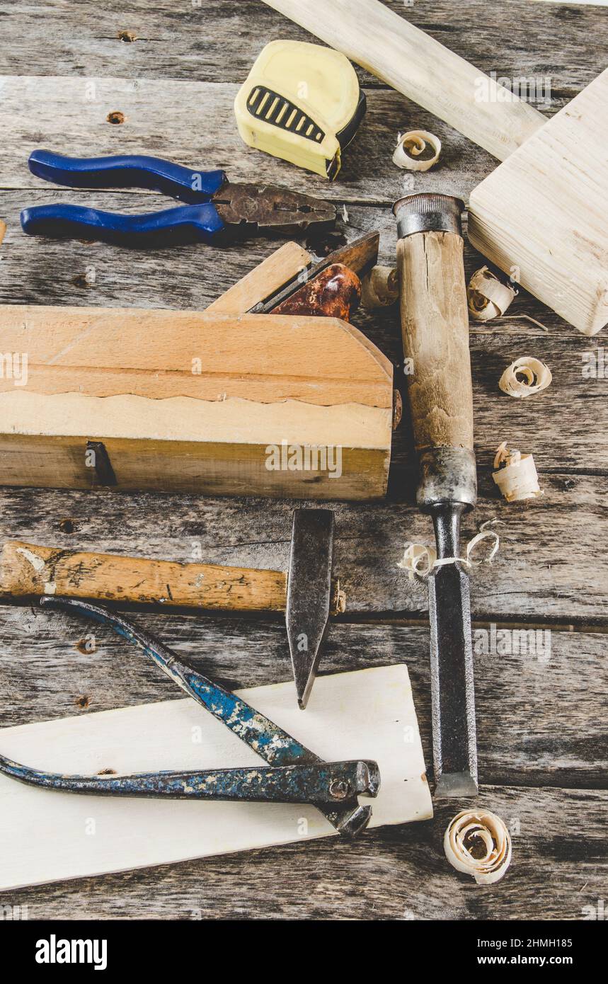 The carpenter tools on wooden bench, plane, chisel,mallet, tape measure ...