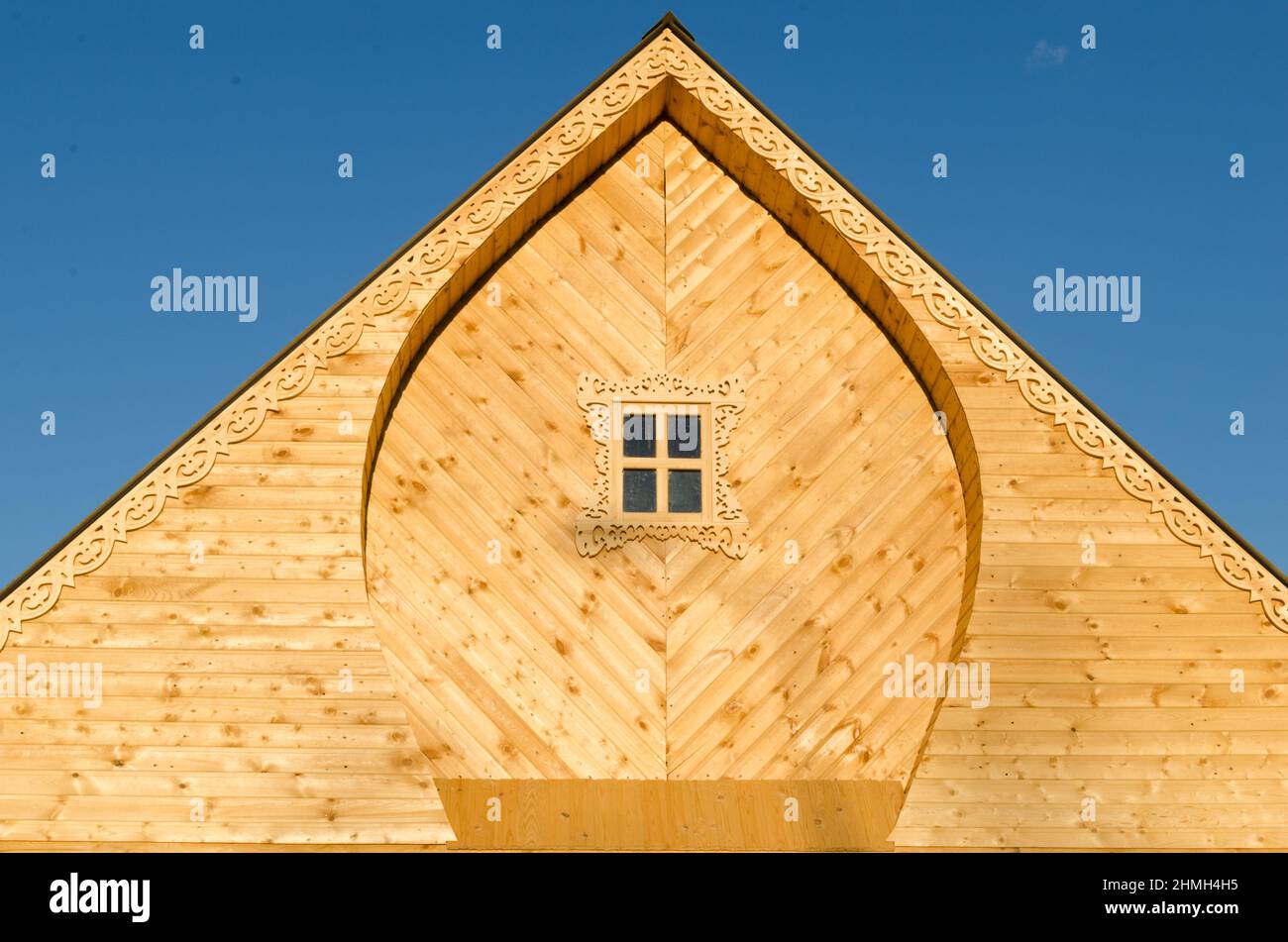 The roof of wooden house on volna blue sky Stock Photo - Alamy