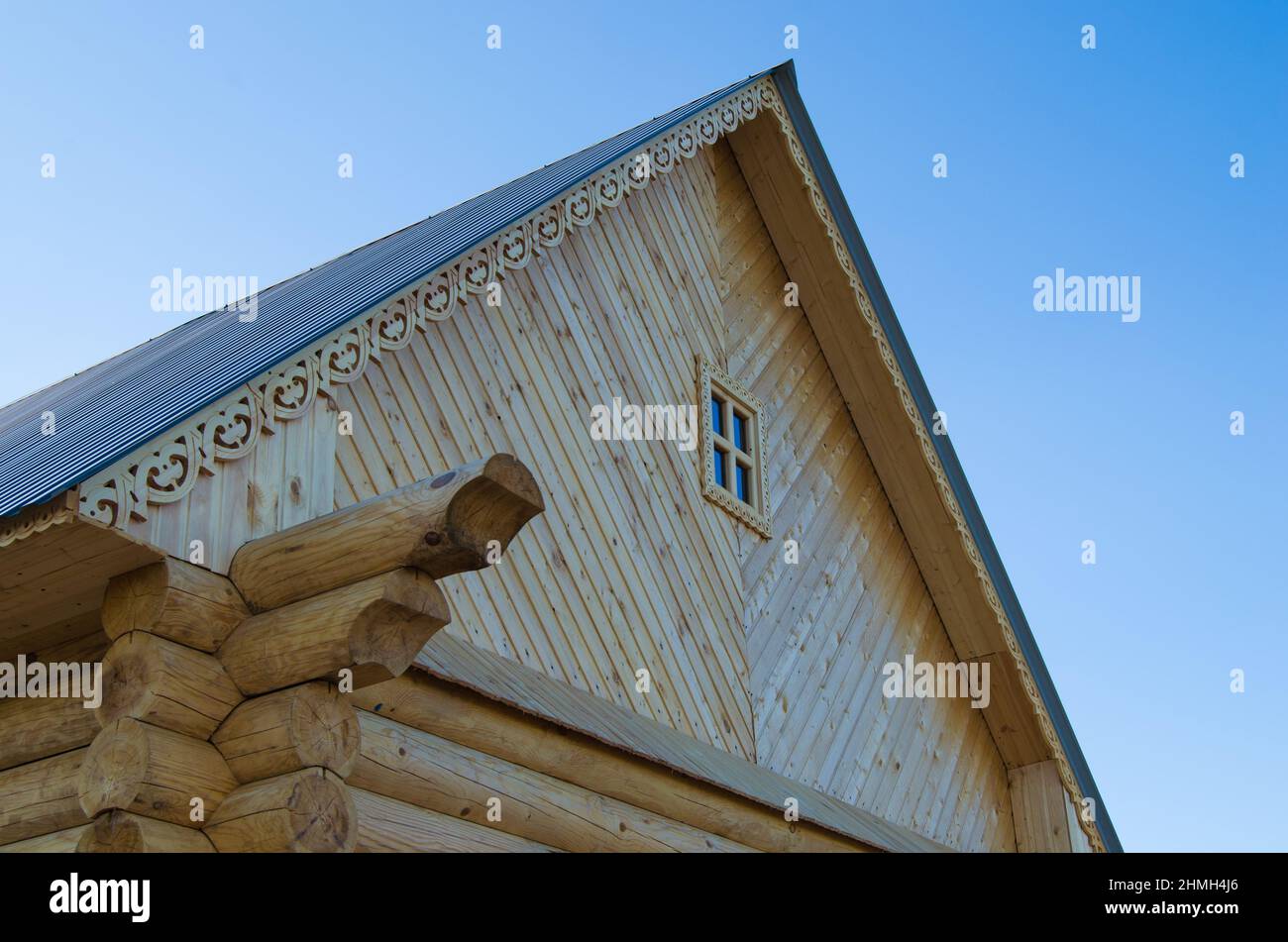 The roof of wooden house on volna blue sky Stock Photo - Alamy