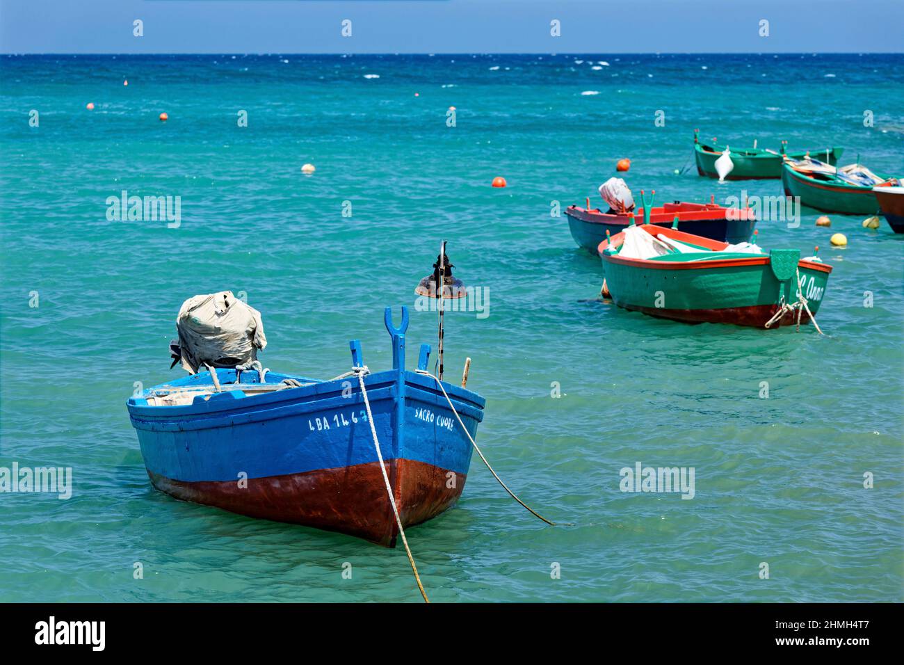 Fishing boats float on the water in Polignano a mare Stock Photo