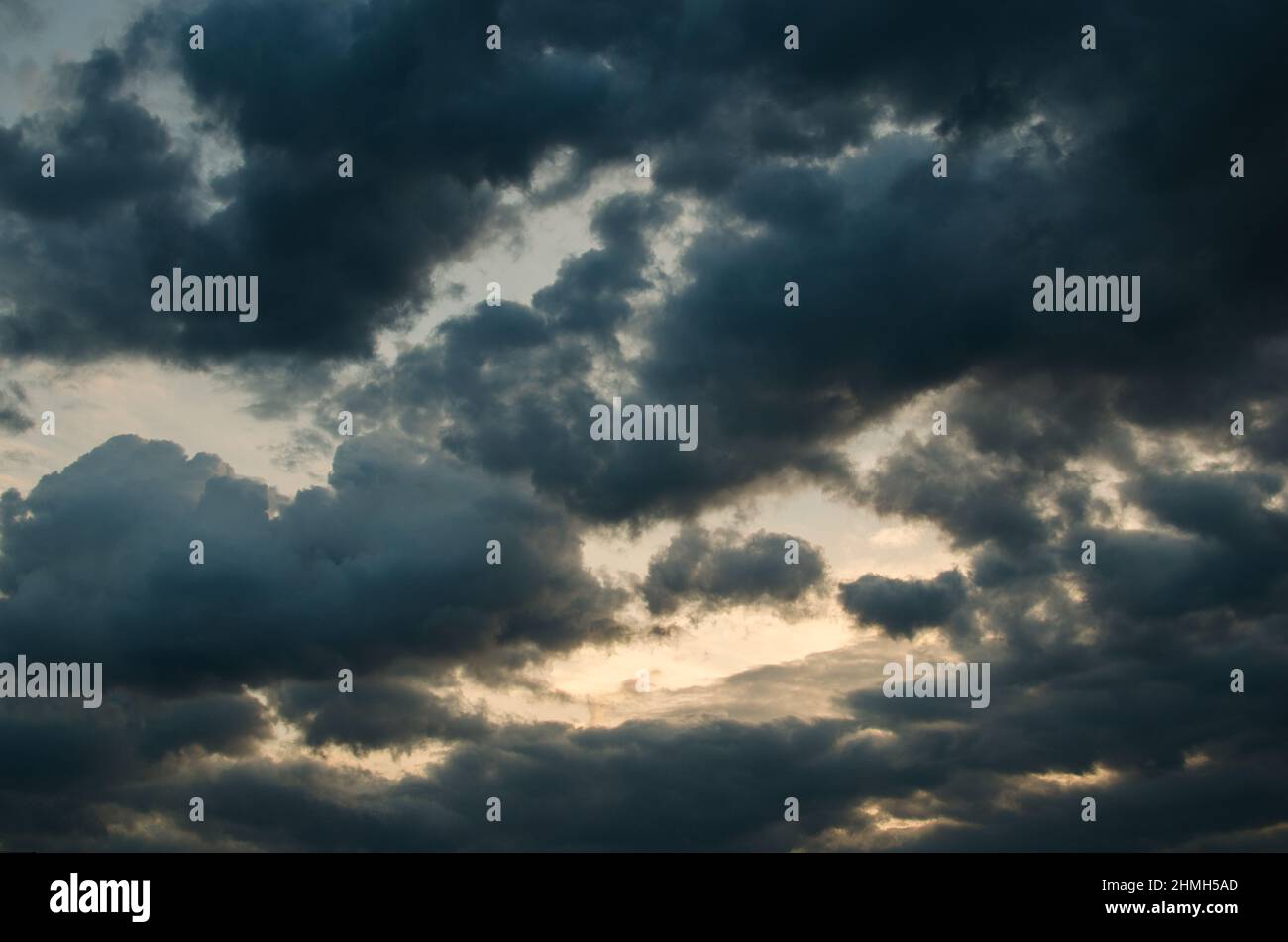 Bright Cumulus clouds in sunset light after the rain Stock Photo