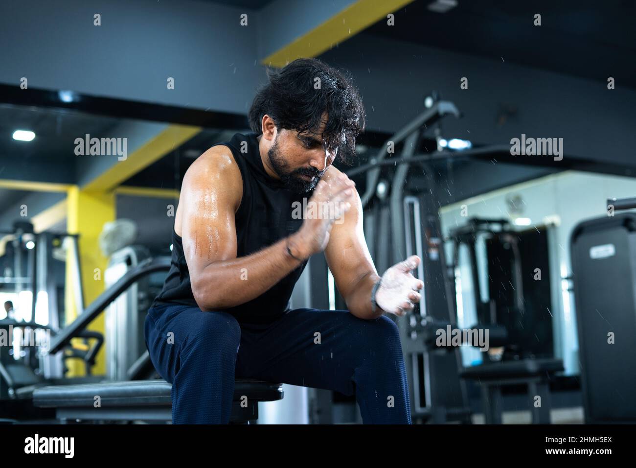 Young sweat indian body builder clapping hands with powder at gym - concept  of hard workout, healthy lifestyle, body fittness and motivation or Stock  Photo - Alamy