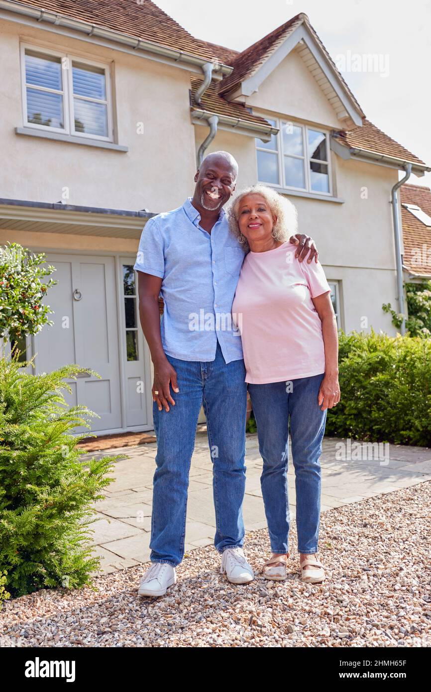 Portrait Of Smiling Senior Couple Standing Outside Home Together Stock ...