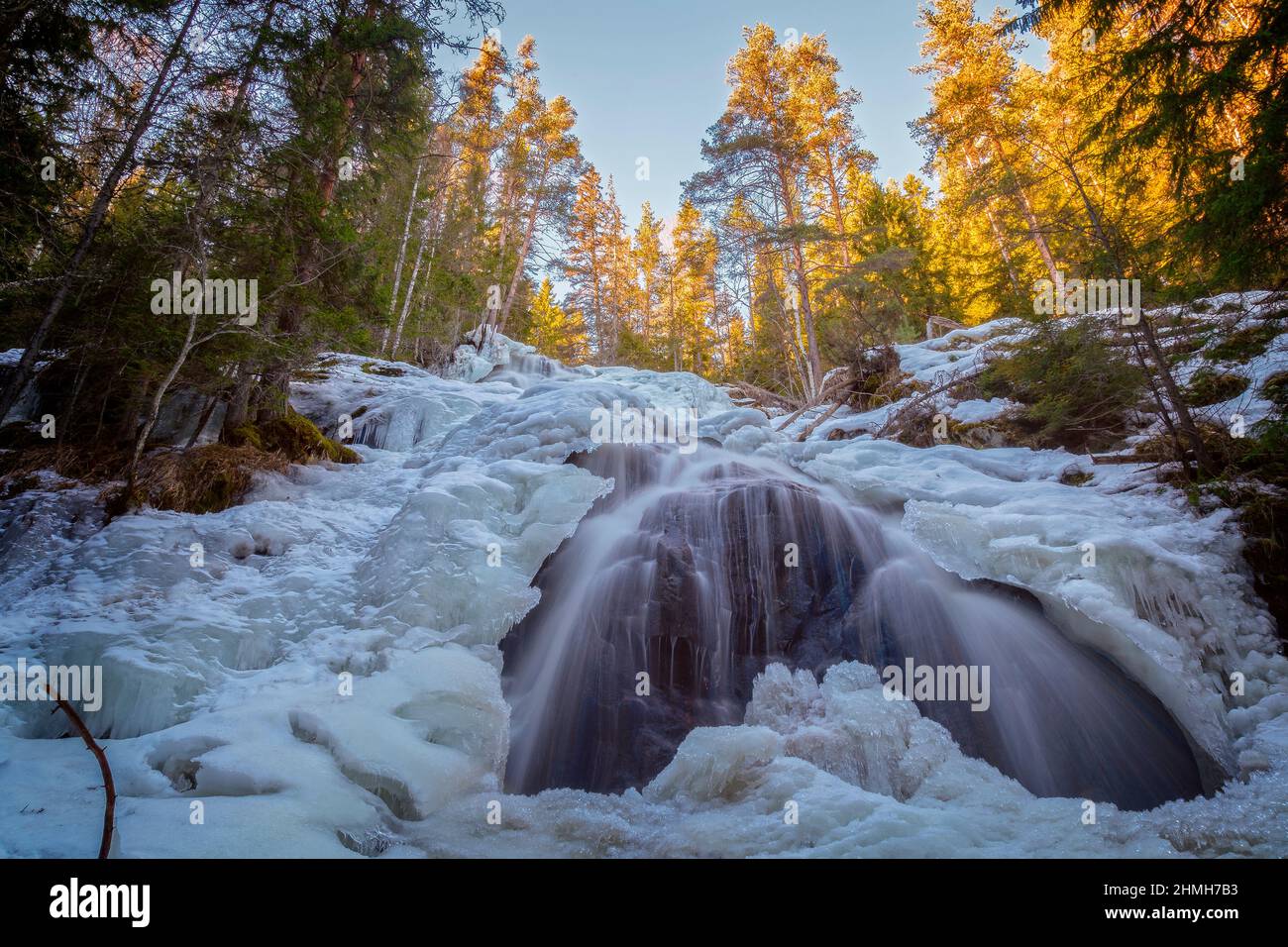 waterfall with ice and snow in a forest Stock Photo