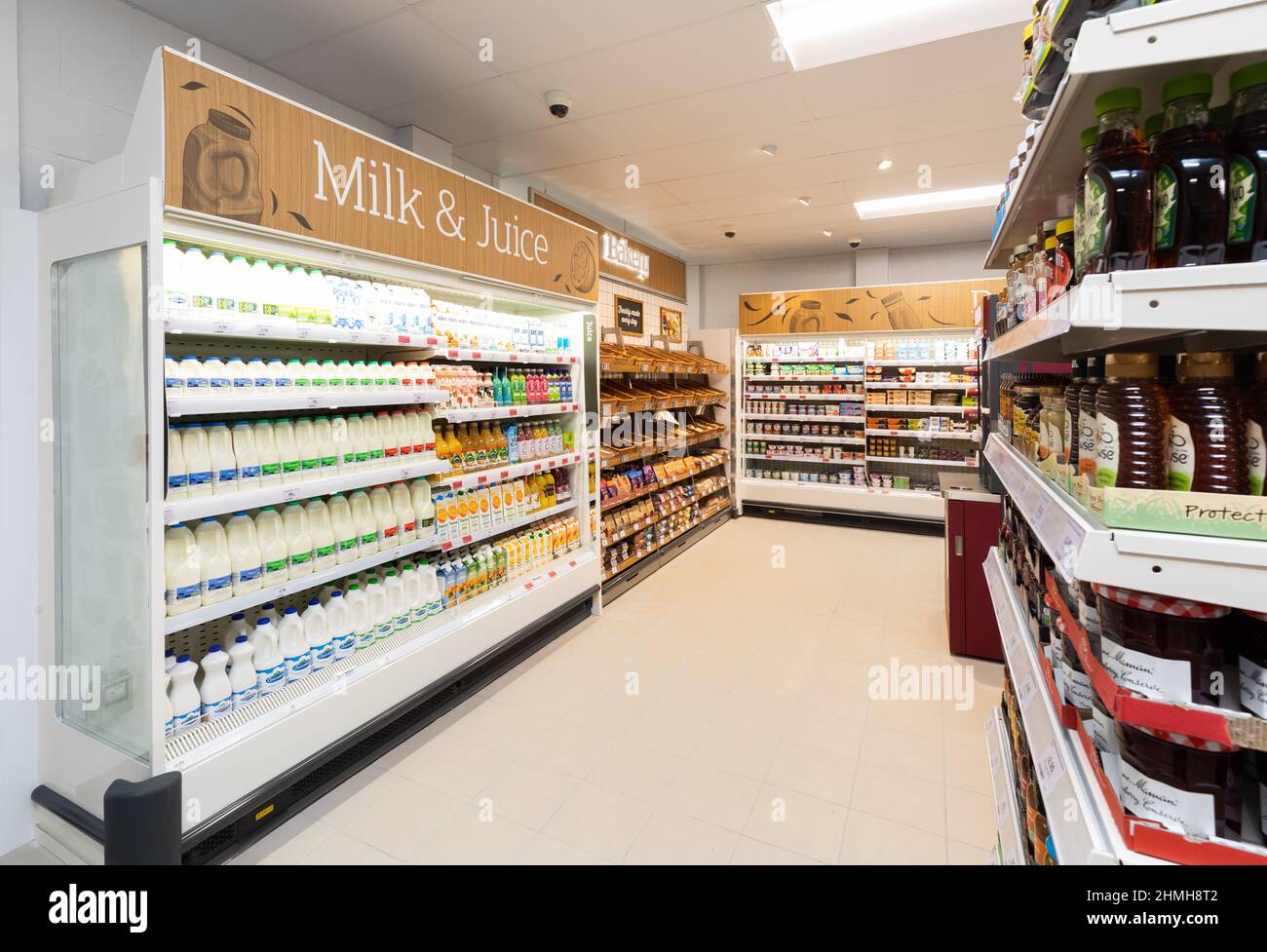 Inside a  Sainsbury's Local store in the UK, showing the Milke and Juice aisle Stock Photo