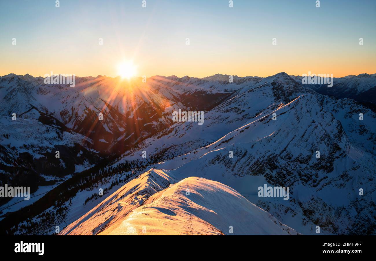 Beautiful sunset over alpine mountain landscape on a cold winter day. View from the Hochschrutte (Ammergau Alps) to the Lechtal Alps. Tyrol, Austria, Europe Stock Photo