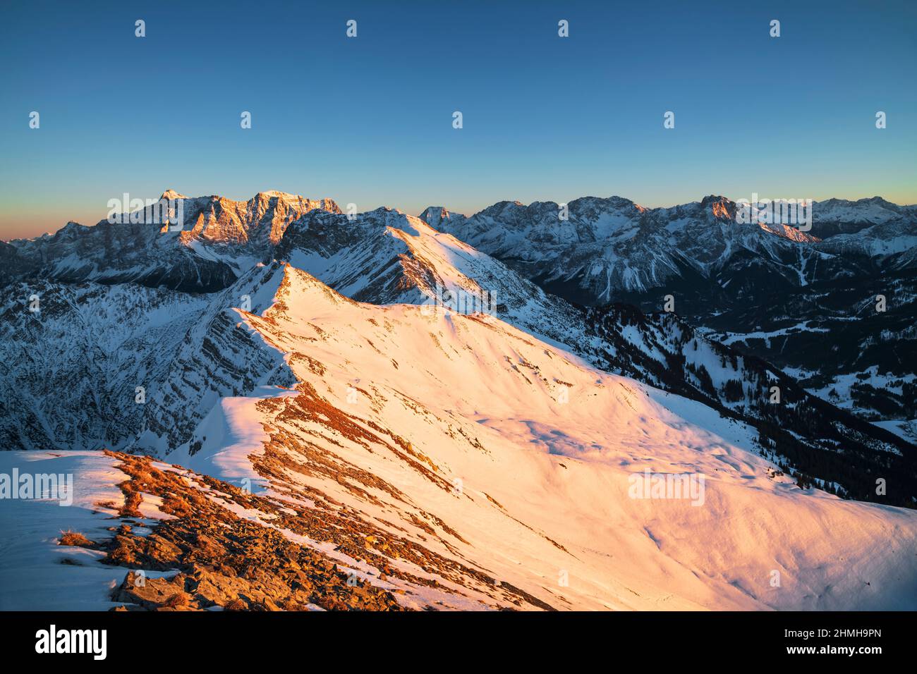 Beautiful sunset over alpine mountain landscape on a cold winter day. View from the Hochschrutte (Ammergau Alps) to the Zugspitze and the Mieminger chain. Tyrol, Austria, Europe Stock Photo
