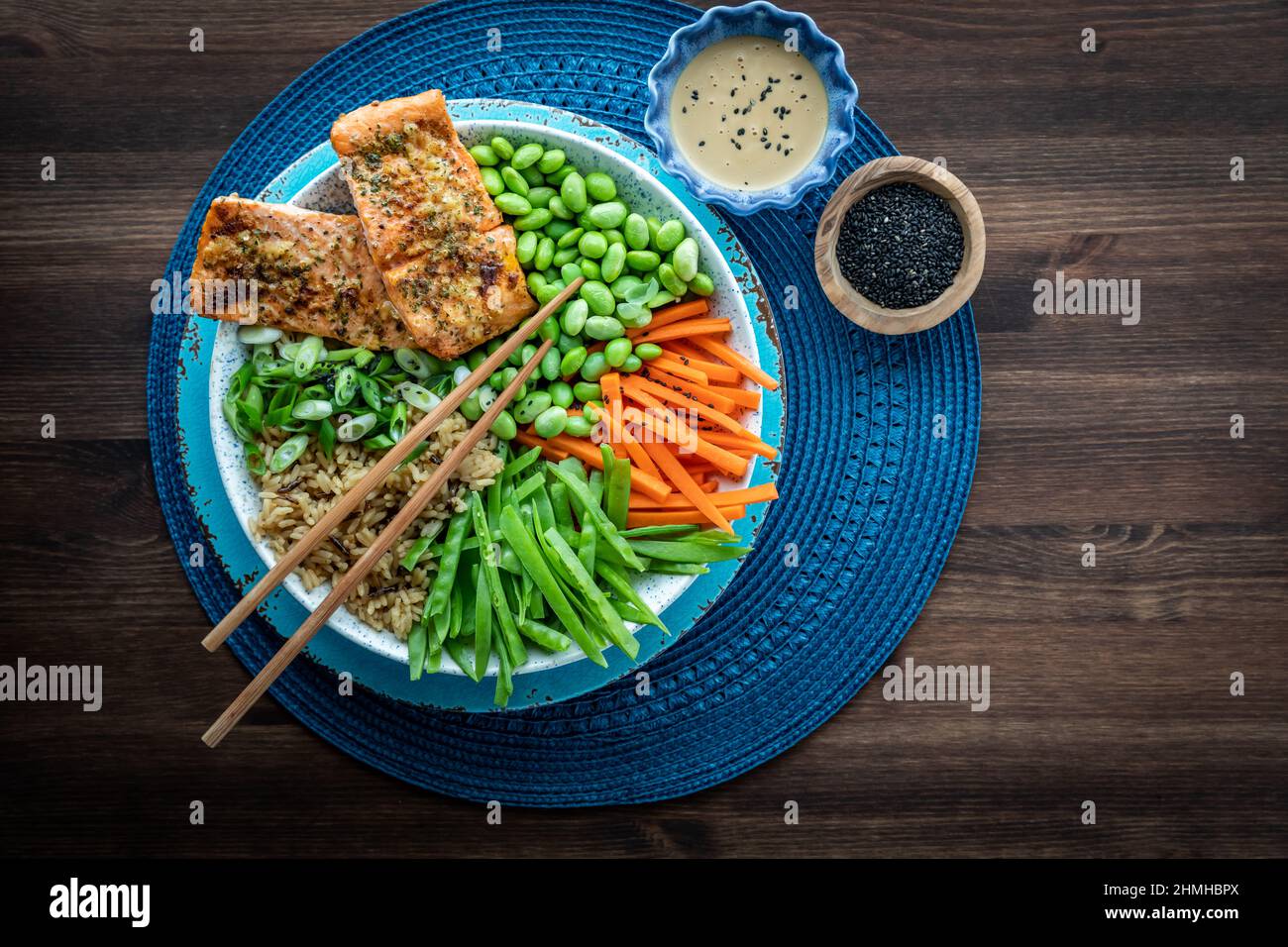 Top down view of an Asian salmon salad bowl with sesame seeds and