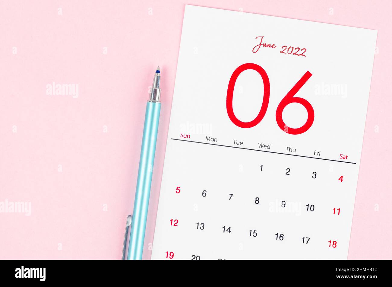 The June 2022 calendar with pen on pink background. Stock Photo