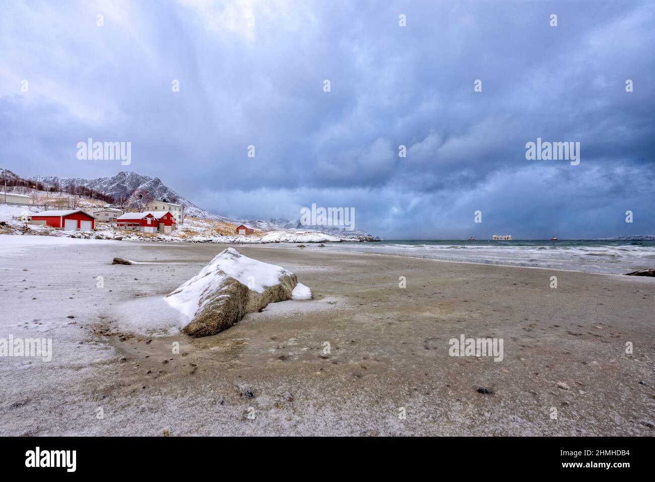 On the snow covered beach of the grotfjord in northern norway hires stock photography and