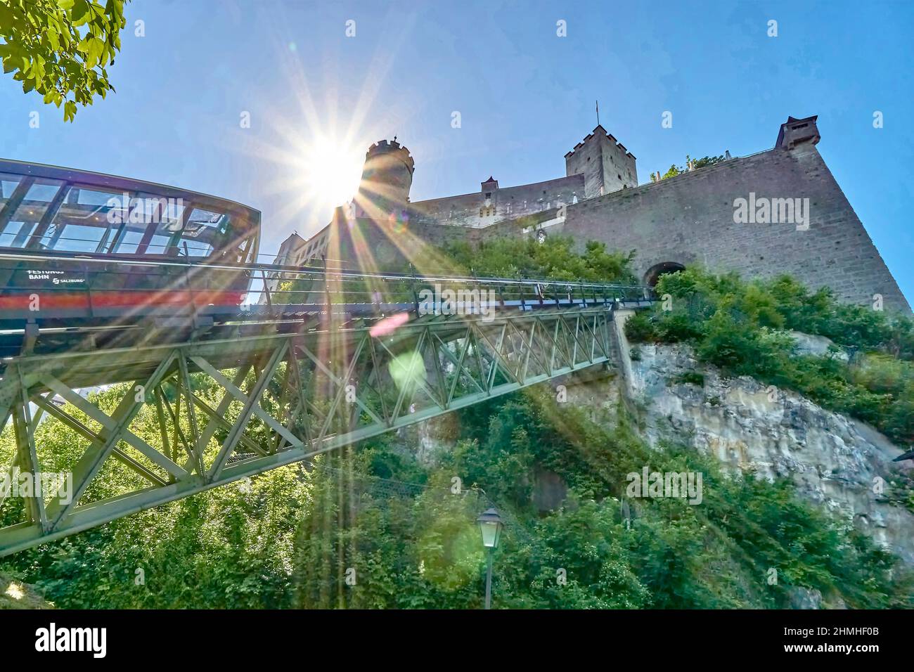 Austria, City of Salzburg, Festungsbahn with Hohensalzburg Fortress, blue sky and sun star in the back light Stock Photo