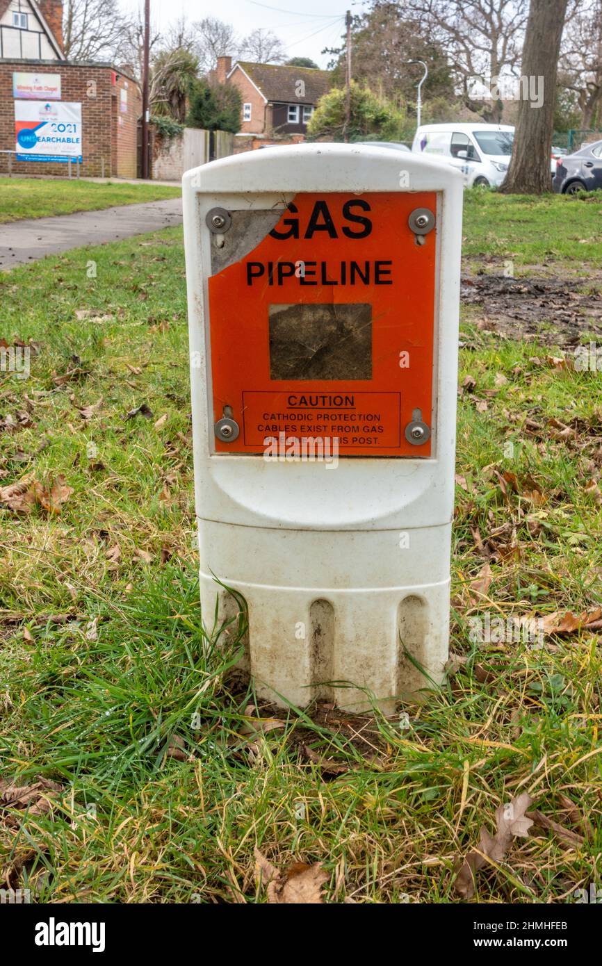 A plastic marker in the middle of an are of gas informs people of the location of a gas pipeline under the ground. Stock Photo