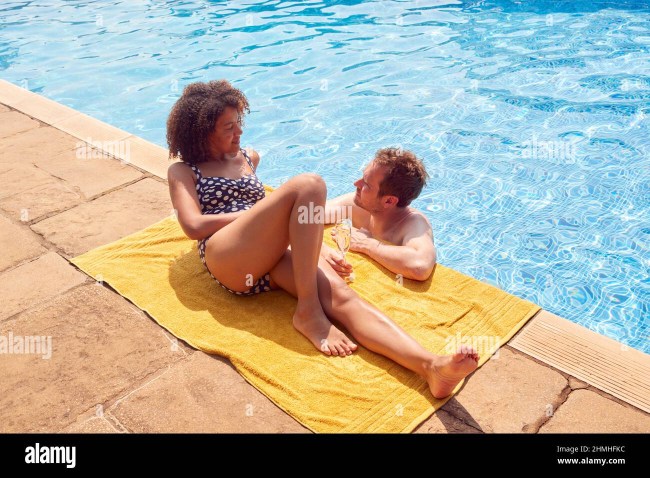 Romantic Couple Drinking Champagne In Swimming Pool On Vacation Stock Photo