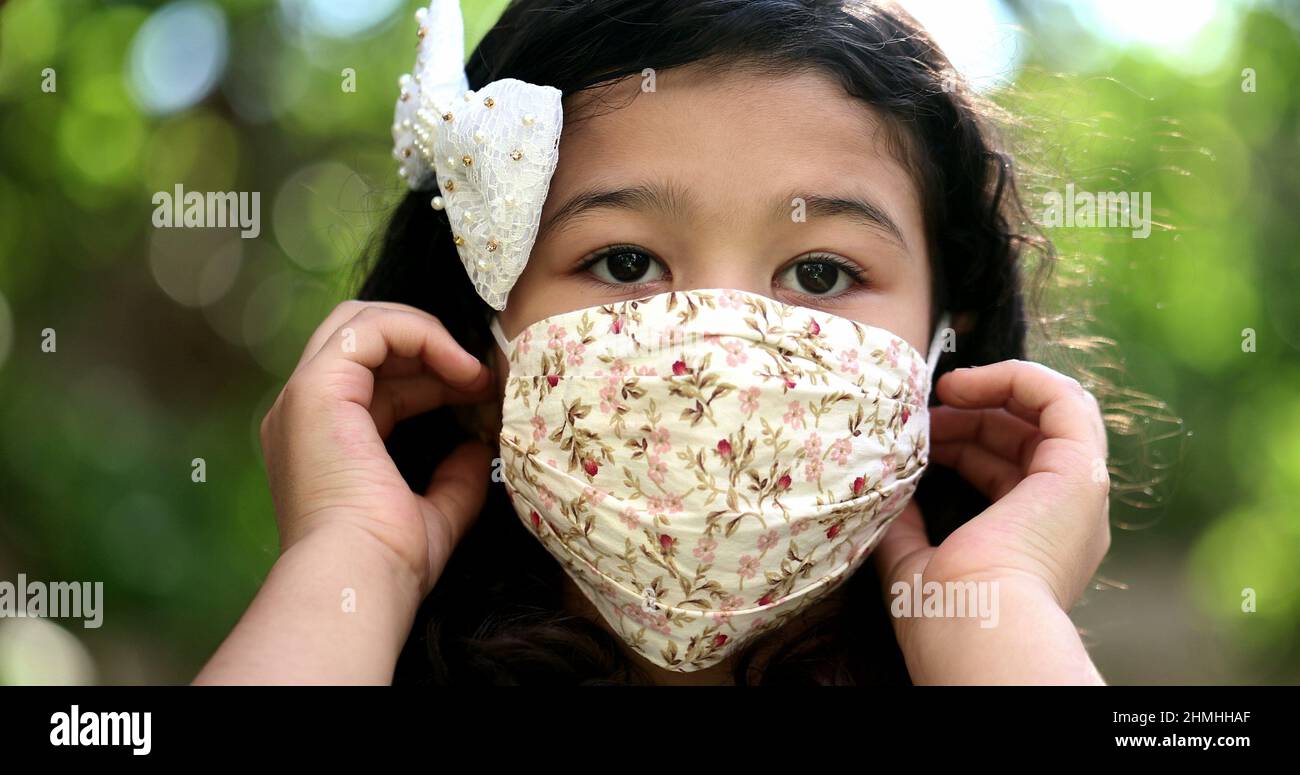 Little girl child removes face mask feeling relief, taking a deep ...