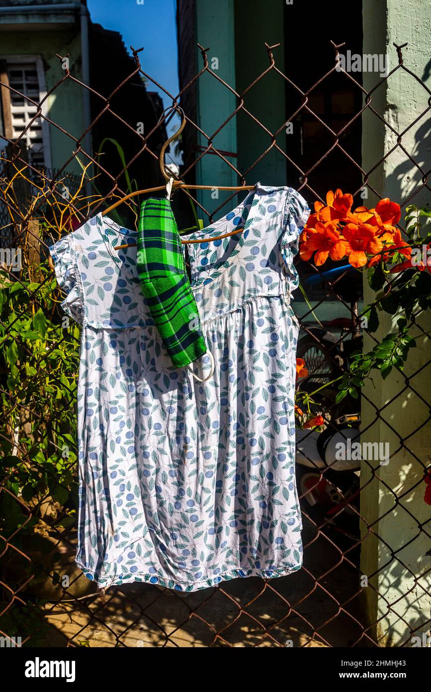 Todays wardrobe drying with a woman's top in the sun. Stock Photo