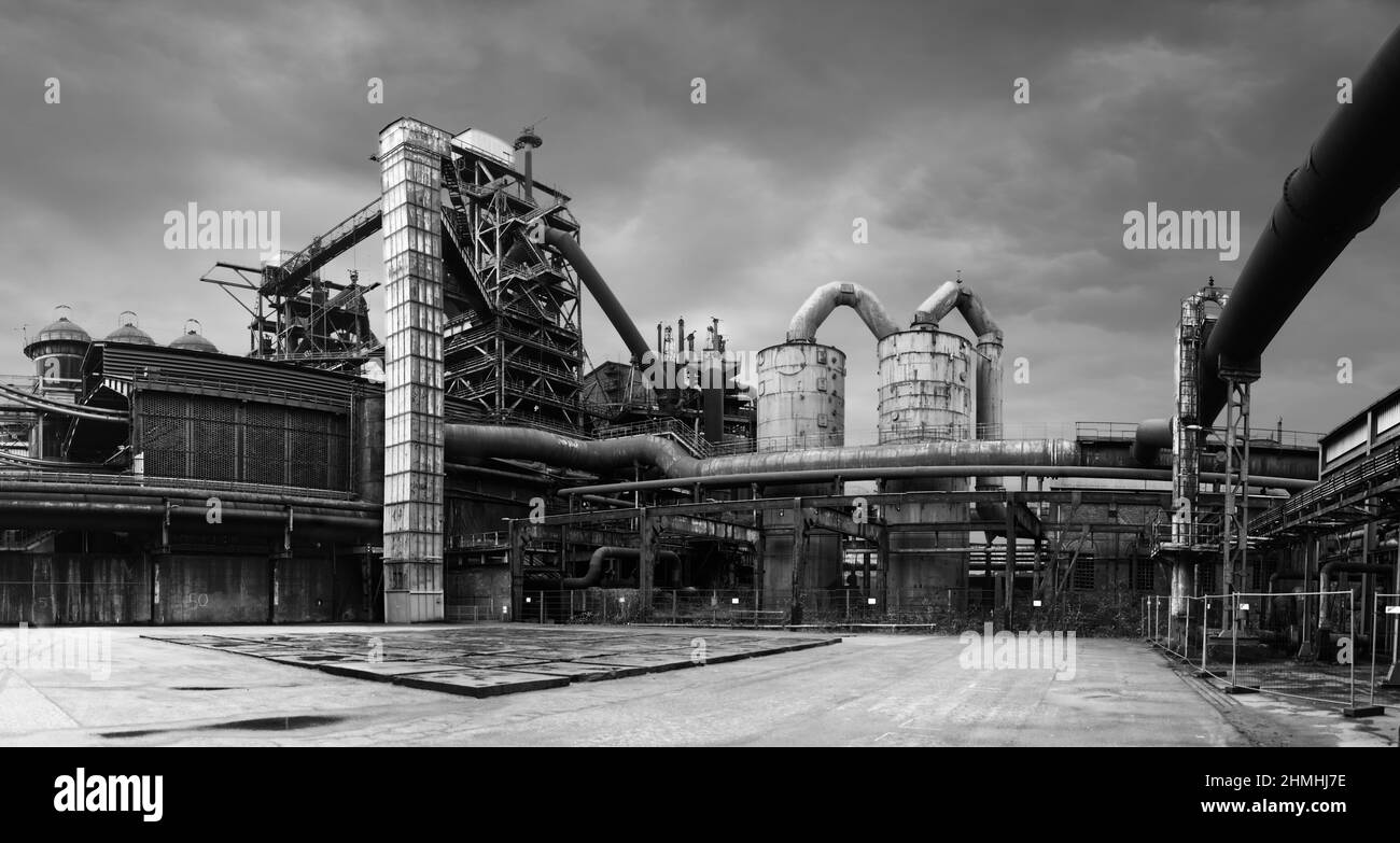 Blast furnace gas plant with gas towers and gas pipes at a place covered with sandstone slabs in the former iron and steel works in the landscape park Stock Photo