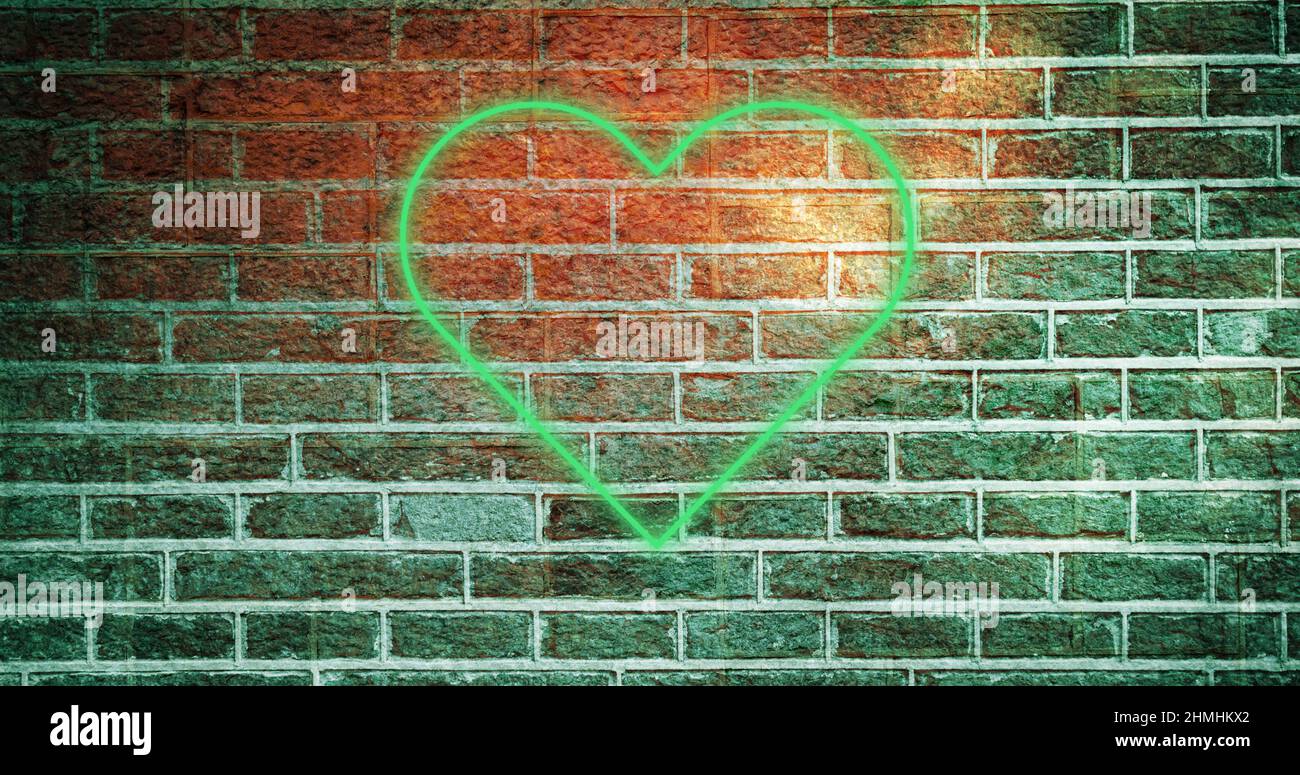 Image of glowing neon heart icon on brick wall Stock Photo - Alamy