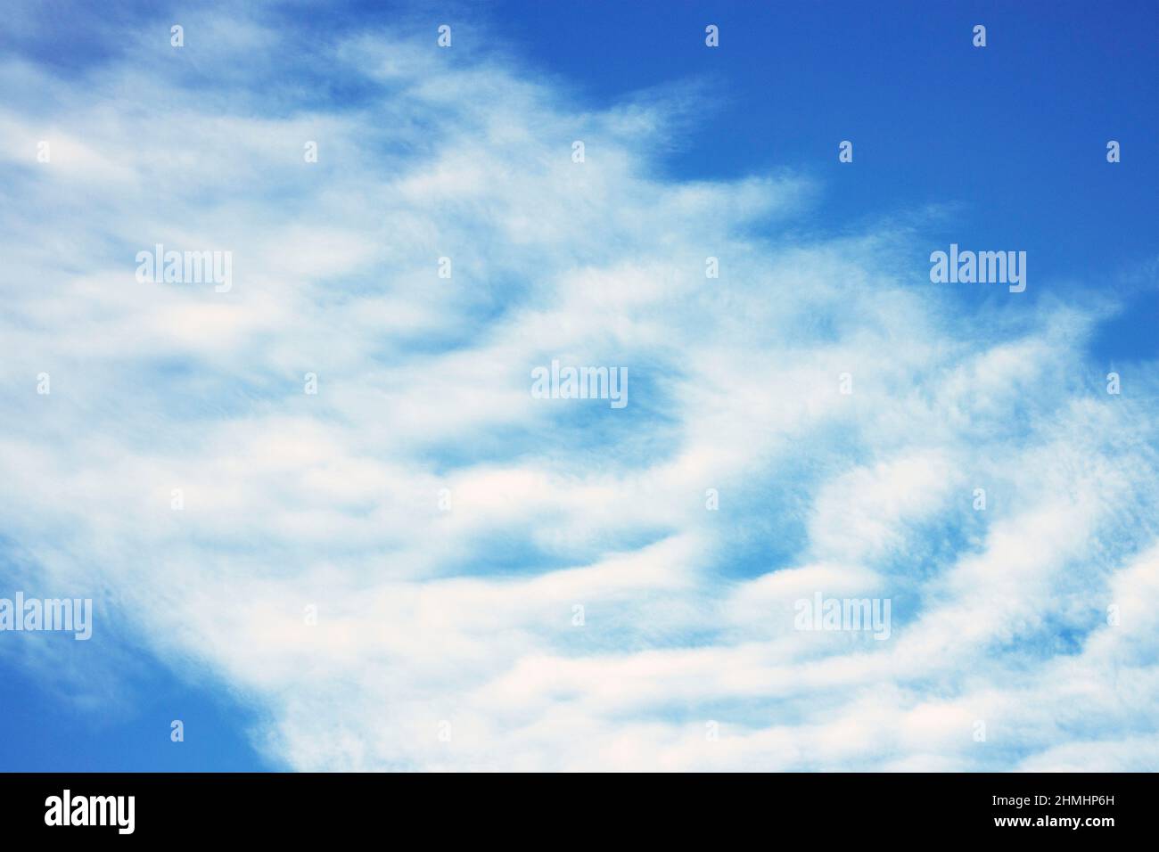 Cirrocumulus clouds form high in the atmosphere. Upper level winds can be over 150 km/h and makes these clouds fast moving and ephemeral Stock Photo