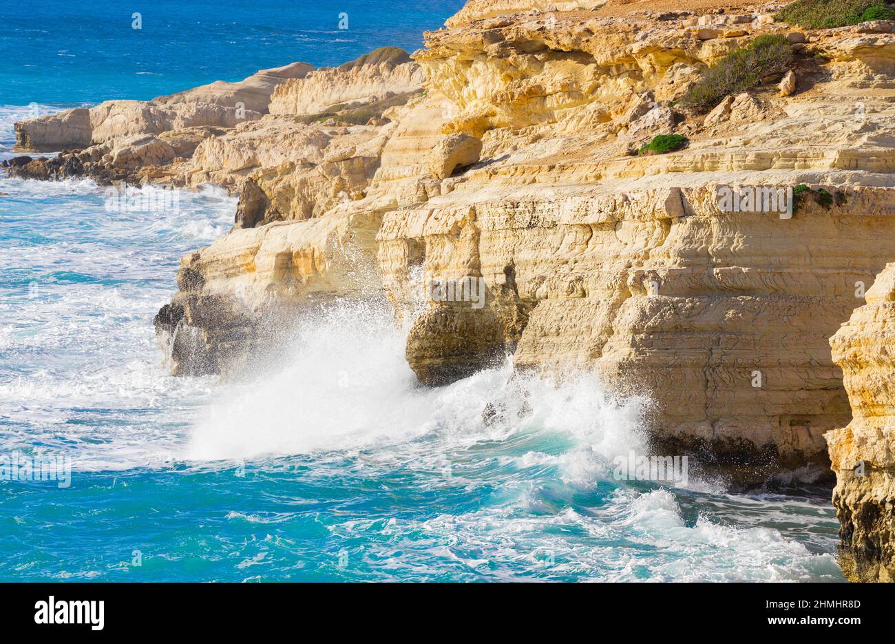 Ocean waves splash against beach with rocks background, Cliffs in the sea, Top aerial view of