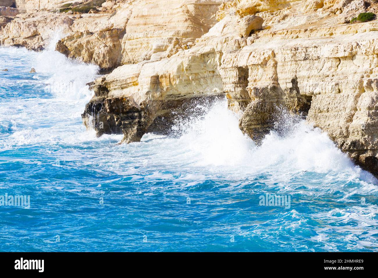 Ocean waves splash against beach with rocks background, Cliffs in the sea, Top aerial view of