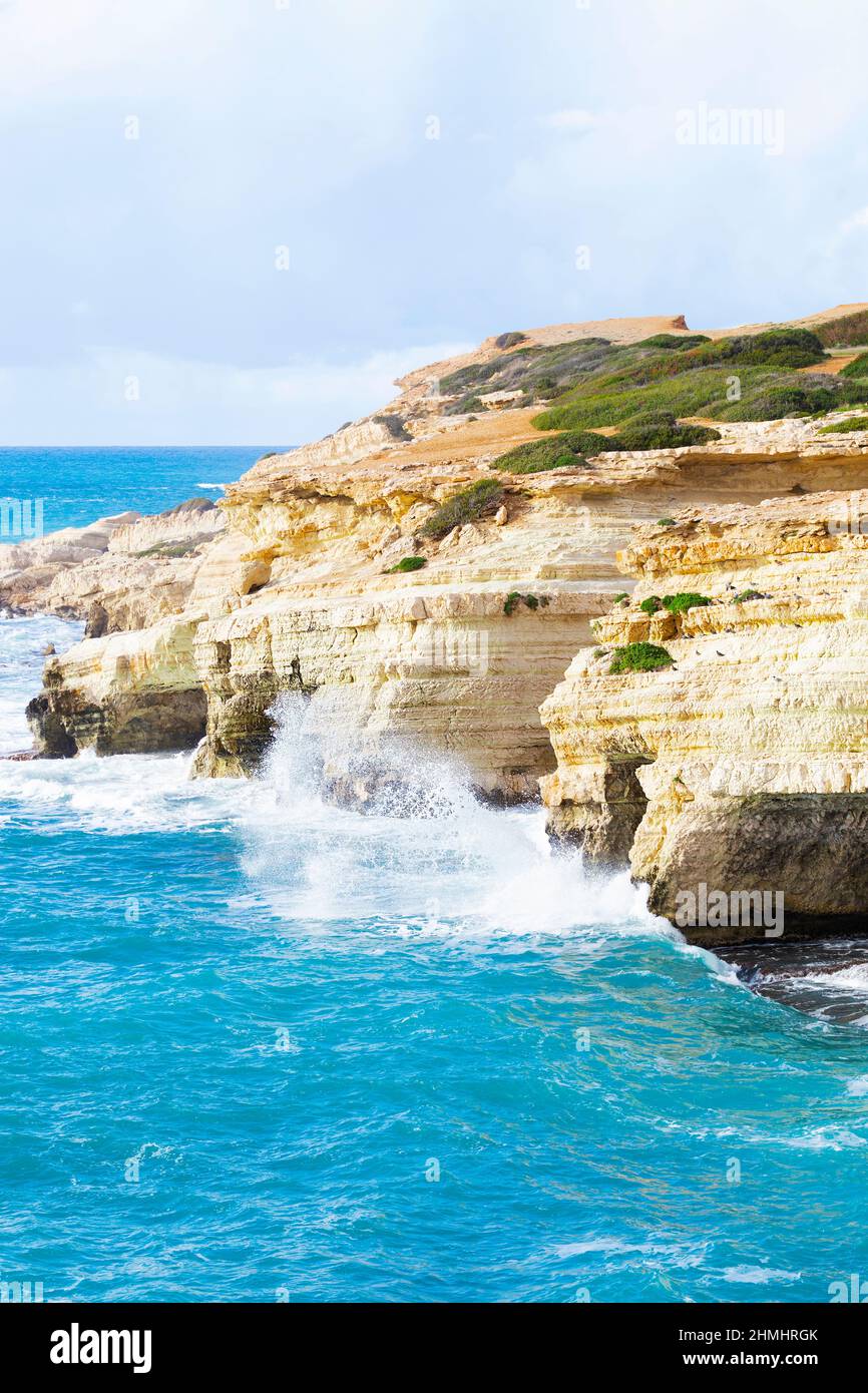 Ocean waves splash against beach with rocks background, Cliffs in the sea, Top aerial view of