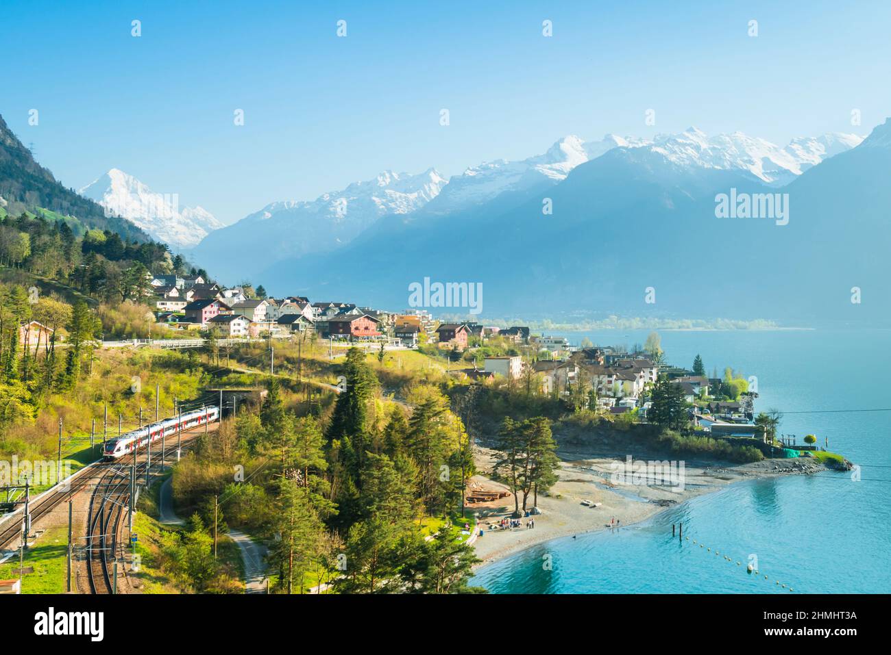 View of the small town in the Alps mountains. Railway along Lake Lucerne. Canton of Uri. Stock Photo