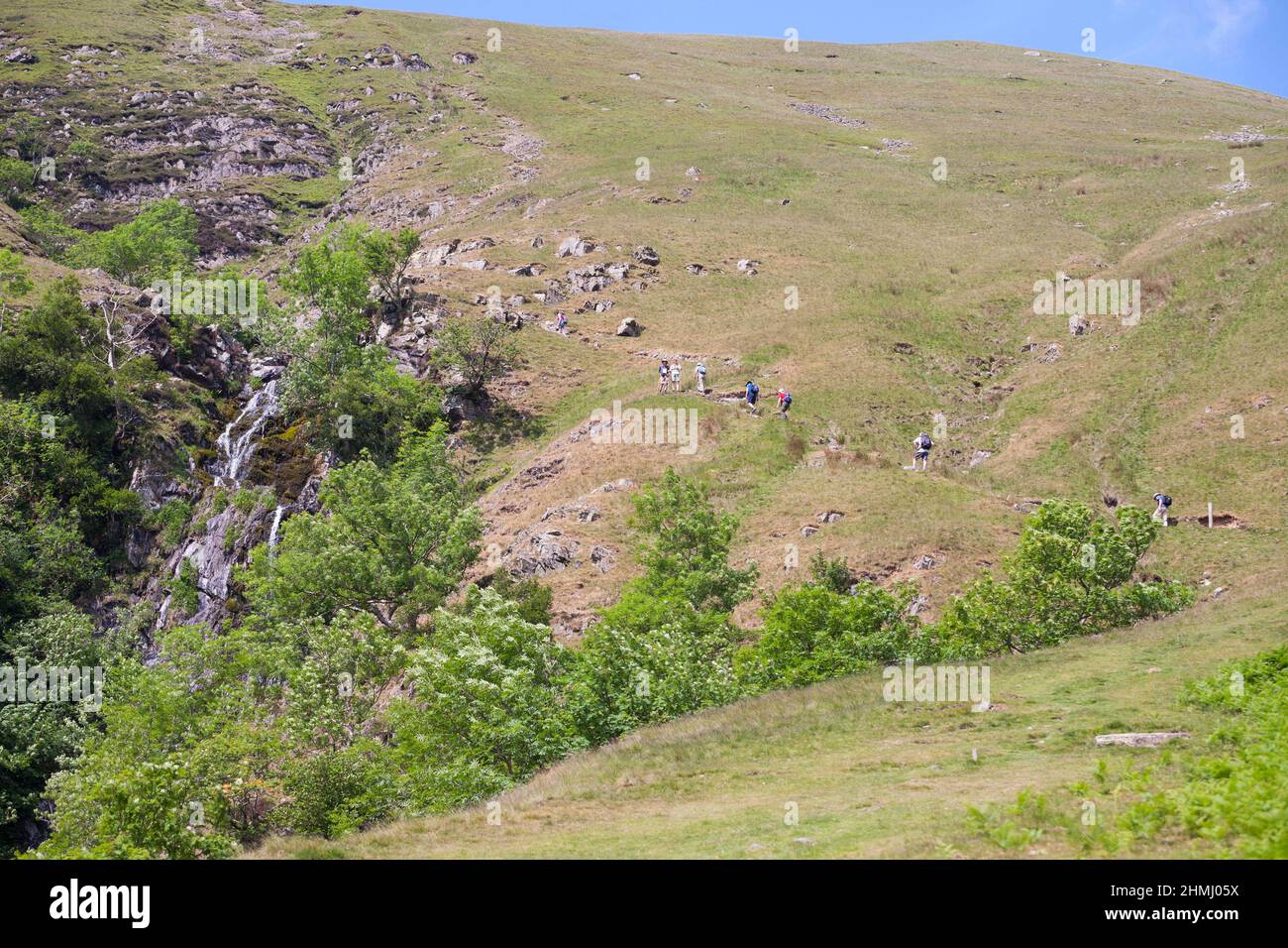 A group of walkers climbing Howgill Fells next to Cautley Spout waterfall, near Sedbergh, Cumbria, England, UK Stock Photo