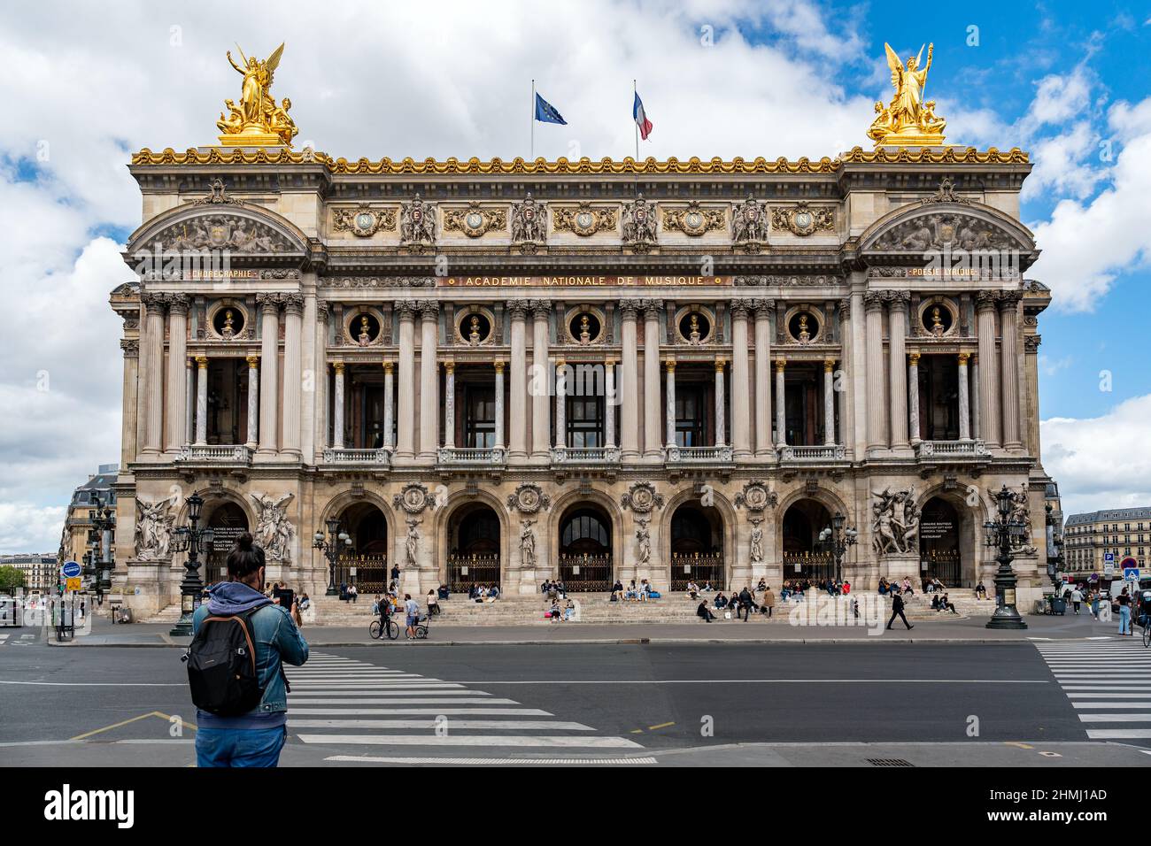 Parisians relaxing on the steps of the Opera Garnier house - Paris, France Stock Photo