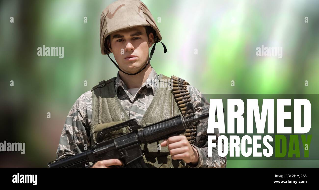 Digital composite image of text over caucasian young male soldier standing with rifle Stock Photo