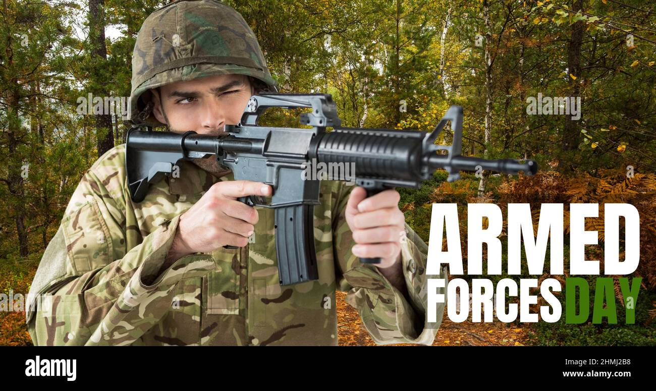 Digital composite image of armed forces day text on caucasian young male soldier with rifle Stock Photo
