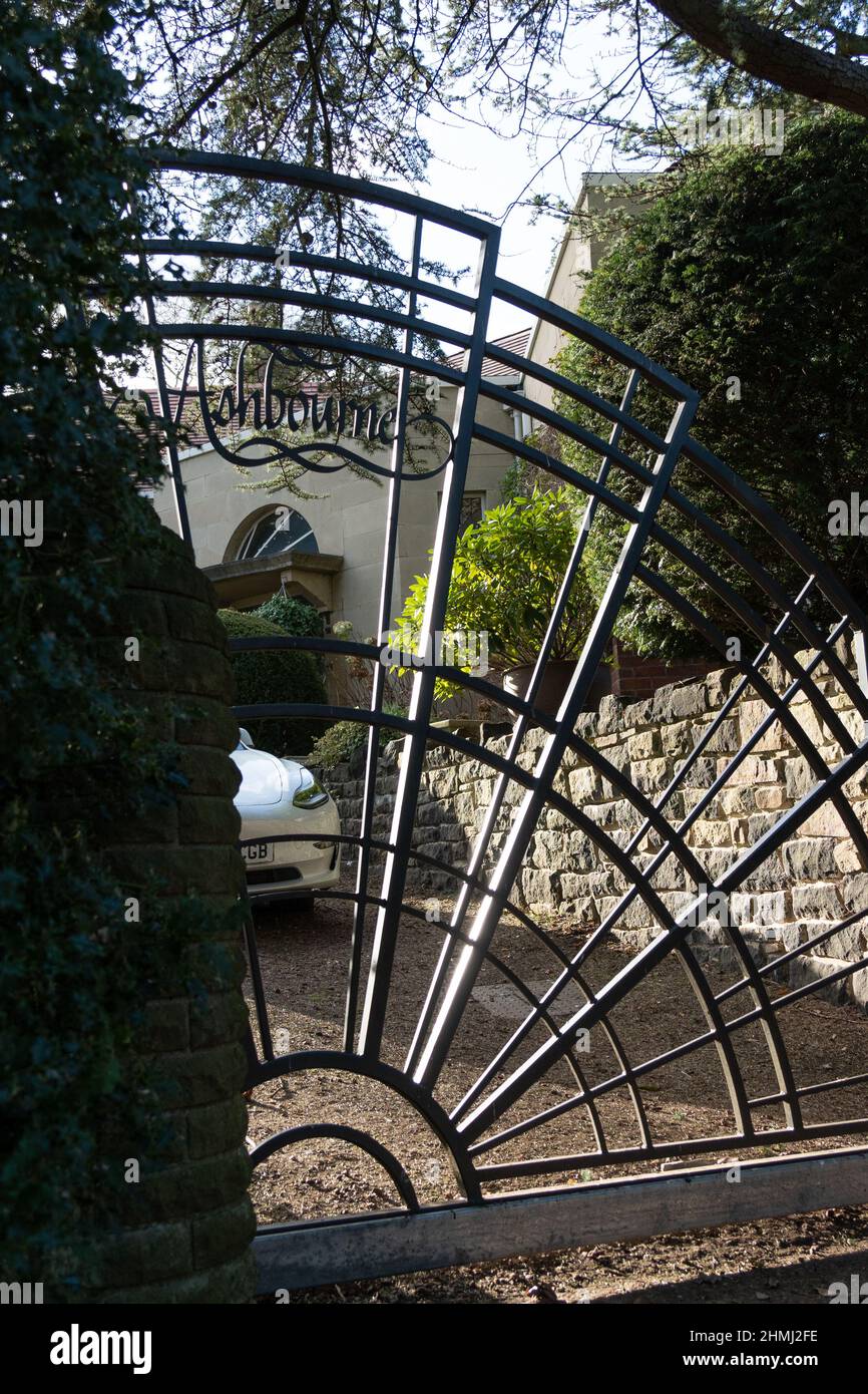 Gate to a des res property in a suburban area in the UK. Wealthy area concept. Stock Photo