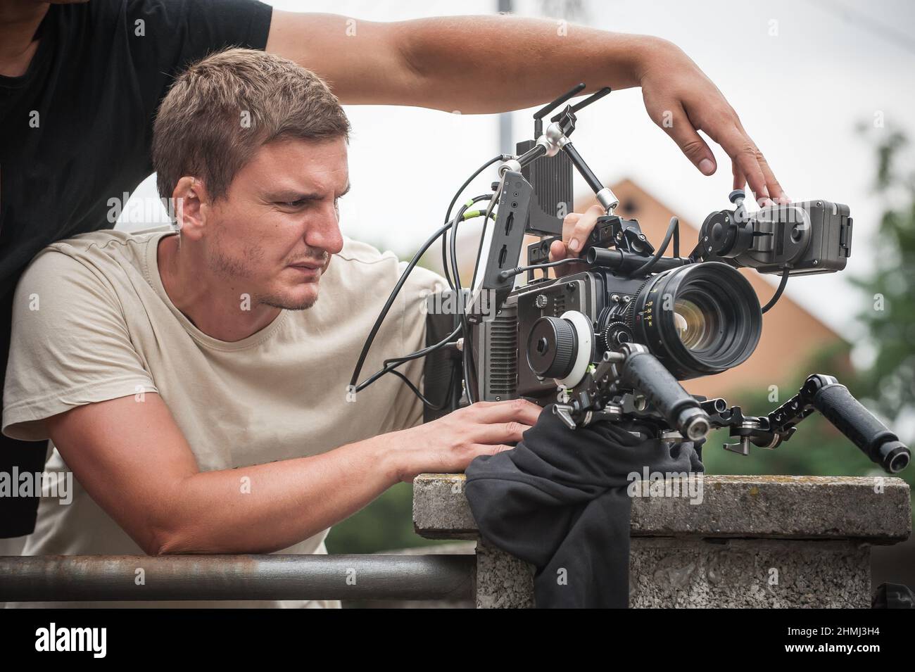 Behind the scene. Cameraman shooting the film scene with his camera on outdoor set. Photography