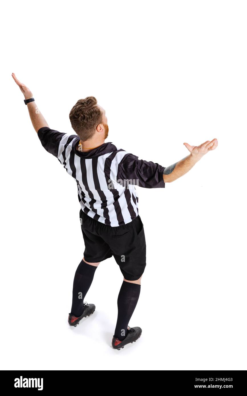 Back view. Fulllength portrait of soccer or football referee wearing