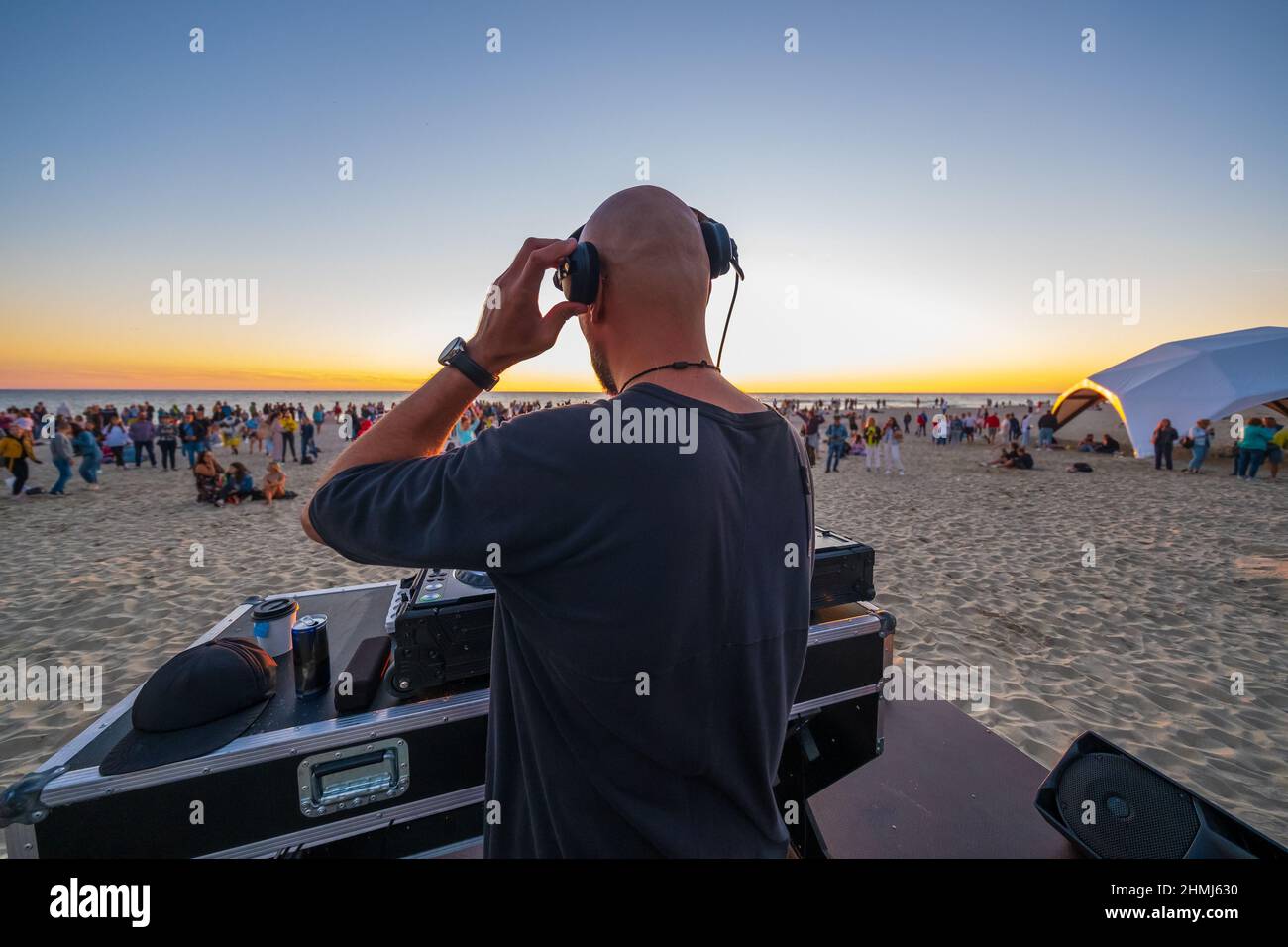 DJ playing music on beach during sunset Stock Photo Alamy
