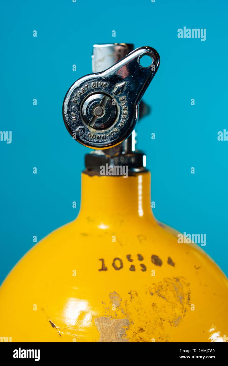 J valve in the reserve position on a vintage yellow steel scuba tank