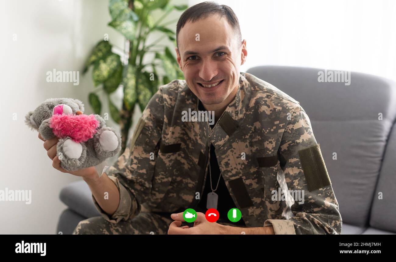 Mature male soldier using laptop in headquarters building for ...