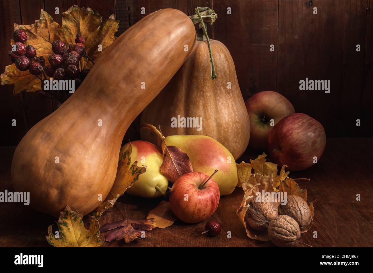 pumpkin and fruits in bulk on a dark wooden background in a rustic style Stock Photo