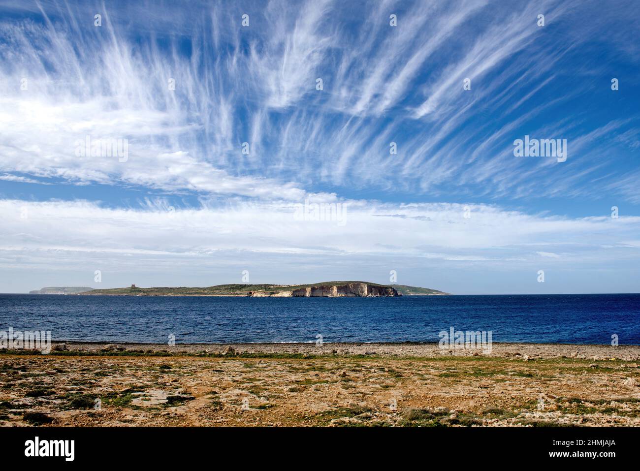 Maltese landscape with  gold rocks over the sea in the Malta island with the blue clear sky and view to Gozo island, Malta, Gozo Stock Photo