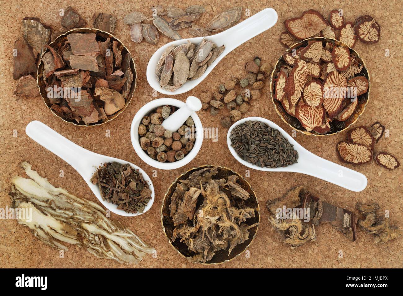Natural plant based traditional Chinese herbal medicine with herbs and spice for alternative health care. Top view on cork background. Stock Photo